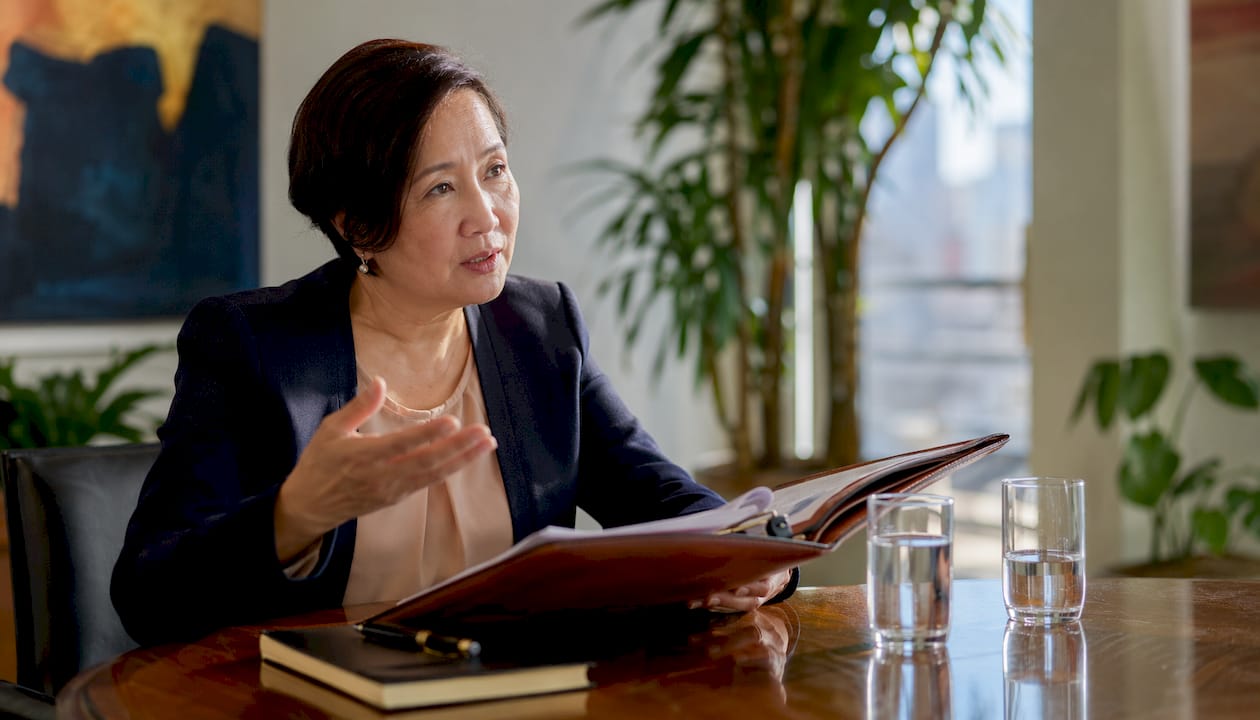Senior legal counsel advising board in formal room
