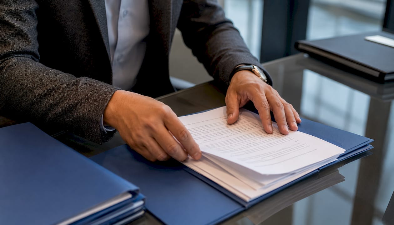 Hands organizing arbitration documents in UK room