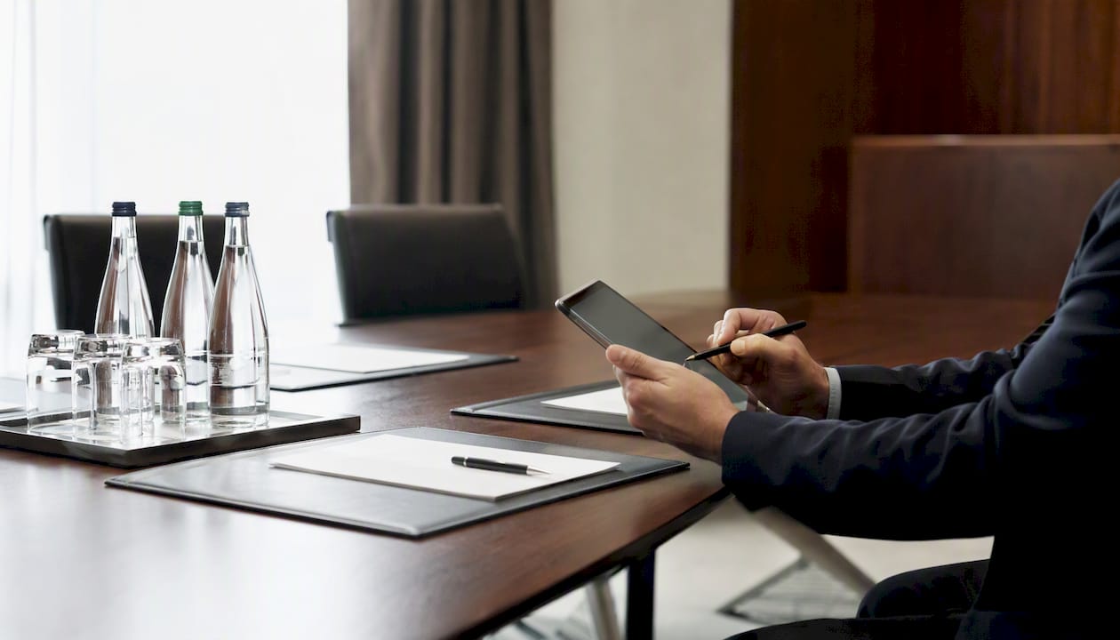 Mediator hands taking notes on tablet