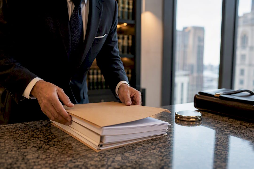 Lawyer hands sorting merger documents